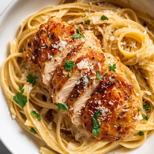 Crispy Chicken Breast Slices Over Creamy Pasta