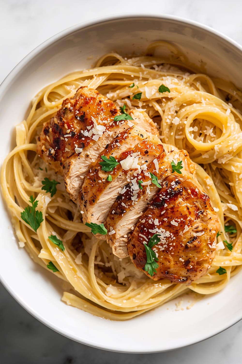 Crispy Chicken Breast Slices Over Creamy Pasta